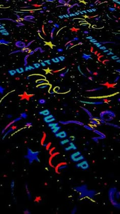 a black background with stars and confetti all over the place that is lit up