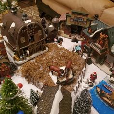 a christmas village is shown with lots of toys on the table and in front of it