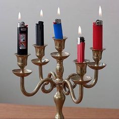 a small candelabra with lighters on it's sides and candles in the middle