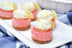 small desserts with lemon and whipped cream on a white plate next to a basket