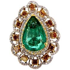 Green Pear Allure. 8.63ct. Natural GIA Certified Emerald Ring GIA Certified Report ID: 5161616364 18.78 X 12.46 X 5.71mm Full cut pear brilliant Clean Clarity & Transparent Vivid Green / Zambia Best GIA= "F2" 12 Natural Fancy color Diamonds. Ovals, Cushions & Pear all full cut brilliants Fancy Color yellow orange brown Vs-2 clarity. 2.00ct round, white diamonds G-color Vs-2 clarity. 18kt. white gold 19.2 grams Ring Current size: 7.5 Depth of ring: .53 inch Deck of ring: 1.44 X 1.08 inch (Free Resize Service, Please inquire) Video upon request. $60,000 Appraisal Certificate to accompany & GIA Pink Diamond Halo Ring, Emerald Diamond Ring, Diamond Cocktail Rings, Fancy Color Diamonds, Zambia, Yellow Diamond, Natural Emerald, Emerald Diamond, Pink Diamond