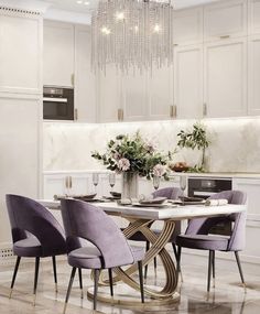 a dining room table with purple chairs around it