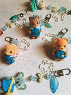 several keychains with teddy bears on them sitting on a table top next to each other