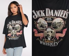 Vintage 1989 Jack Daniel's whiskey t shirt in black. Please see measurements and condition below. Every garment we sell is authentic vintage and one-of-a-kind! You will receive the exact item photographed. Condition: Very good vintage. Best fits women's: 2XL Best fits men's: Extra Large Material:  Cotton Polyester blend MEASUREMENTS Taken from seam to seam while the garment is lying flat. Double the armpit, waist, and hips For reference, model is 5'10" and measures 31-23-34.  Length from Top: 28 Jack Daniels Shirt, Whiskey Shirt, Calico Dress, Plaid Jumper, Dolly Dress, Mod Mini Dress, Black Graphic Tee, Country Music Shirts, Tennessee Whiskey