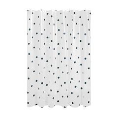 a white shower curtain with black dots on it