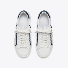 Our classic court sneaker — inspired by a '70s-era tennis shoe — is updated with our signature emblems: a decorative ruffle and Double T. The Howell is lightweight and comfortable, featuring a cushioned footbed and a flexible outsole.