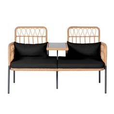 two wicker couches with black cushions and side table on white background, front view