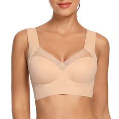 a woman wearing a tan bra with her breast exposed and no bra, in front of a white background