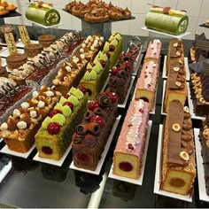 many different types of cakes and desserts on display