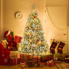 a decorated christmas tree in a living room with presents around it and a clock on the wall