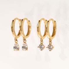 These 14K Gold Small Hoop earrings will be your favorite earrings for the wedding day and everyday after. 14K Gold Moissanite Crystals Hypoallergenic, lead and nickel free Thickness 1.8mm Diameter Sizes: Inside 8.2mm Stone Diameter: 3mm Click Snap closure #ES055-G Second Piercings, Gold Small Hoop Earrings, Second Piercing, Minimal Earrings, Small Hoop Earrings, Gold Earrings Designs, Huggie Earrings, Yellow Gold Earring, Gold Collection