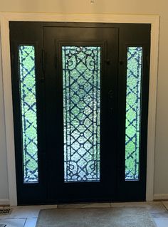 the front door is decorated with an intricate glass design