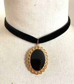 Black smooth velvet choker necklace (1cm wide). Oval gold-plated metal pendant (3.5cmx 2.5cm), black enameled center. Closed with a lobster clasp. Adjustment chain finished with a gold-plated metal drop. All metal parts are made of nickel-free zamac and made in Europe. Black Velvet Choker Necklace, Velvet Necklace, Velvet Choker Necklaces, Black Velvet Choker, Metal Drop, Velvet Choker, Black Choker, Oval Pendant, Gold Enamel