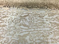 an intricately designed white and gold fabric