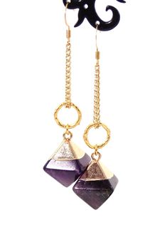 Clip-on style also available! These unique dangle stone earrings make a stunning statement! Semi precious Amethyst stone pendants coupled with 10k gold plated textured rings give these beauties a chic look with a luxurious feel! 18k gold plated wire earring hooks add a delicate touch, completing the earrings!Product De 14k Gold Filled Jewelry With Gemstone Accents, Gold Plated Drop Earrings With Gemstone Accents, Gold Plated Dangle Jewelry With Gemstone Accents, Modern Dangle Jewelry With Gemstone Accents, Modern Brass Earrings With Gemstones, Amethyst Dangle Earrings Fine Jewelry, Fine Jewelry Amethyst Dangle Earrings, Modern Long Drop Gemstone Jewelry, Gold Drop Earrings With Gemstone Accents