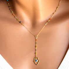 "This is a beautiful Hamsa pendant Y style necklace Necklace is made with faceted gemstones in every color you can imagine on 24kt gold vermeil! Gemstones measure approximately 3mm in size. Necklace may be order in a 16\", 18\", or 20\" length. This is the measurement around the neck only. It does not include the drop. Gold Filled Hamsa pendant measures 20x15mm with a blue enamel eye surrounded with tiny pave crystals. Drop with pendant measures 3 1/4\" (70mm). Necklace has a spring clasp closur Gold Plated Pendant Necklace With Gemstone Accents, Spiritual Yellow Gold Necklaces With Gemstone Accents, Fine Jewelry Gold Plated Necklaces With Gemstone Accents, Spiritual Yellow Gold Necklace With Gemstone Accents, Spiritual Gold Plated Necklaces With Natural Stones, Spiritual Gold Beaded Lariat Necklace, Gold Spiritual Dangle Crystal Necklace, Spiritual Pendant Necklace With Jewels, Gold Gemstone Drop Necklace For Gift