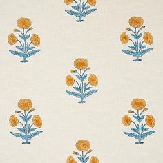 an orange and blue flower pattern on white fabric