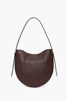 Elevate your everyday style with the Victoria Beckham Hobo Bag in burgundy, where timeless sophistication meets practical design. Crafted from the finest supple leather, this bag offers a relaxed silhouette that embodies understated luxury. Its slouchy, yet structured shape drapes beautifully whether worn over the shoulder or carried by hand, offering a versatile, casual-chic look. Victoria Beckham Medium Dia Hobo Bag In Burgundy Smooth Leather  - Size ONE SIZE UK Burgundy Shoulder Bag With Gold-tone Hardware For Office, Office Burgundy Shoulder Bag With Gold-tone Hardware, Elegant Burgundy Leather Bucket Bag, Burgundy Leather Shoulder Bag For Office, Classic Burgundy Shoulder Bag With Double Handle, Burgundy Bags With Leather Handles For Office, Classic Burgundy Shoulder Bag For Work, Luxury Burgundy Bags For Work, Modern Burgundy Bags For Work