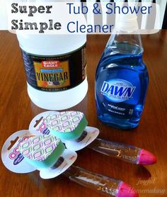 some toothpaste, mouthwash, and other items are on a wooden table