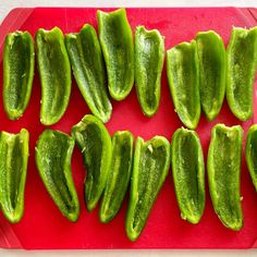 several pieces of pickle sitting on a red cutting board