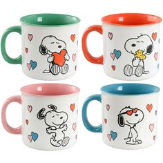 four coffee mugs with cartoon characters on them, one has a dog and the other has hearts