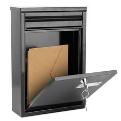 a black fire place with an open door and a key hanging from it's side