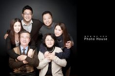 a group of people are posing for a photo in front of a black background with the words photo house written on it