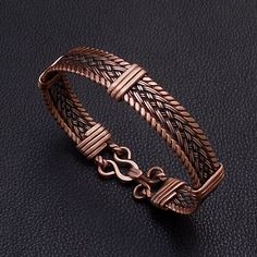 This unique braided copper bracelet is entirely hand crafted with braided twisted and hammered wrapped pure copper wire . Unique cuff men bracelet gift for husband and wife for 7th copper wedding anniversary . Width : 1,3 cm -0,5 " Copper is oxidized to give it an antique appearance . Please read about copper care on Info & Faq section. The requested piece it's made to order similar with the original shown item . Please be sure to read the entire description of the item before you purchase. Item Braided Metal Bracelets As Gift, Adjustable Brown Copper Braided Bracelets, Rose Gold Wire-wrapped Copper Bracelets, Adjustable Hand Wrapped Copper Wire Bracelets, Hand Wrapped Copper Bracelets In Brown, Hand Wrapped Brown Copper Bracelets, Handmade Copper Braided Bangle Bracelet, Copper Braided Bangle Bracelet Gift, Adjustable Copper Braided Bohemian Bracelet