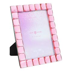 a pink and purple photo frame sitting on top of a table