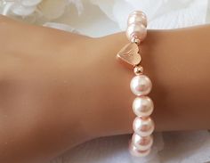 This personalized flower girl bracelet is made with blush pink color little glass pearls (8 mm) and rose gold plated hand stamped heart charm. This stretch pearl bracelet is perfect gift for your flower girls, jr bridesmaids or bridesmaids. Please visit my store to see the other wedding jewelry https://www.etsy.com/shop/asteriasbridal Adjustable Beaded Bracelets With Heart Charm For Wedding, Adjustable Pearl Bracelet For Wedding On Valentine's Day, Personalized Rose Gold Bracelets For Wedding, Elegant Beaded Bracelet With Heart Charm For Wedding, Elegant Wedding Beaded Bracelet With Heart Charm, Personalized Rose Gold Wedding Bracelets, Elegant Personalized Rose Gold Beaded Bracelets, Elegant Personalized Rose Gold Beaded Bracelet, Adjustable Rose Gold Heart Bracelet For Wedding