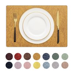 a place setting with white plates, silverware and gold cutlery on a wooden board