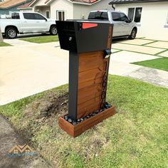 a mailbox sitting in the grass near a house