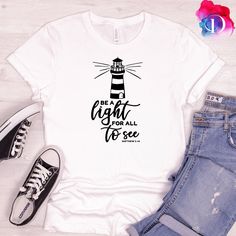 "Be The Light T-Shirt | Religious | Inspirational | Be The Good T-Shirt  | Christian T-Shirt | Jesus lover Shirt | Matthew 5:14  This just might be the softest and most comfortable women's t-shirt you'll ever own. Combine the relaxed fit and smooth fabric of this tee with jeans to create an effortless every-day outfit, or dress it up with a jacket and dress pants for a business casual look. * 100% combed and ring-spun cotton * Athletic heather is 90% cotton, 10% polyester * Other heather colors Sailing Theme, Be The Good, Fabric Painting On Clothes, Matthew 5, Be The Light, Club Ideas, Christian T Shirt, Painted Clothes, Bible Studies