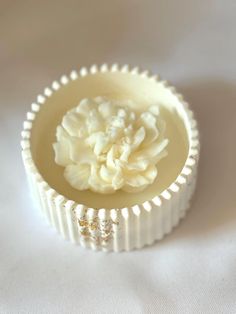 a white cupcake liner with a flower in it