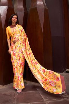 Elevate your saree collection with our Saffron Mango Digital Floral Printed Satin Crepe Saree. The subtle Saffron Mango and delicate floral print exude elegance and sophistication. Made from soft and flowing satin crepe, this saree promises to drape beautifully for any occasion. The running pallu adds a touch of grace, while the plain blouse completes the luxurious look. Experience comfort and style with this party wear saree. Material: Satin Crepe Length: 5.5 meter ( Regular Saree length) Color: Saffron Mango color Blouse Piece Length: 1 meter ( Un- Stitched) Blouse Piece Description: Plain Blouse Piece. Washing Instructions: Light Wash only. Yellow Sari, Satin Silk Saree, Saree Floral, Floral Saree, Crepe Saree, Yellow Satin, Ethnic Sarees, Satin Saree, Party Kleidung