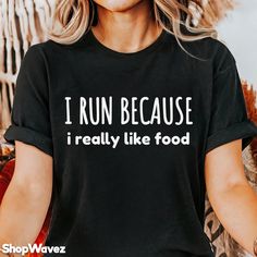 a woman wearing a black shirt that says i run because i really like food