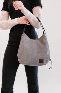 Our Anniston hobo bag is as cute as it is functional. It comes with two magnetic-snap compartments on top of each side of the main zipper-enclosed compartment. This makes it a breeze to throw in your phone or keys that you might need quick and easy access to, while still being able to zip up your wallet or cash in a more concealed and safe compartment. You're going to love the size of this bag too. it's big enough to store your necessities, but you'll never feel like you're carrying around a bul Versatile Everyday Hobo Bag With Zipper Pocket, Versatile Hobo Bag With Zipper Closure, Versatile Hobo Shoulder Bag With Cell Phone Pocket, Versatile Hobo Bag With Cell Phone Pocket, Versatile Hobo Bag For On-the-go, Casual Hobo Bag With Cell Phone Pocket For On-the-go, Everyday Hobo Bag With Zipper Closure, Canvas Hobo Shoulder Bag With Zipper Closure, Canvas Hobo Shoulder Bag With Zipper