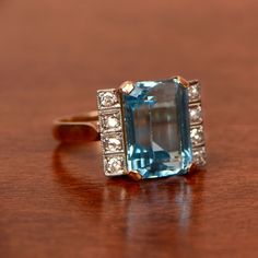 Beautiful vintage aquamarine engagement ring. Aquamarine Brilliant Cut Diamond Ring For Formal Occasions, Formal Aquamarine Diamond Ring With Brilliant Cut, Art Deco Diamond Topaz Ring, Formal Aquamarine Ring With Diamond Accents, Formal Aquamarine Diamond Ring With Prong Setting, Formal Blue Topaz Asscher Cut Ring, Formal Asscher Cut Blue Topaz Ring, Art Deco Topaz Ring With Diamond Center Stone, Formal Octagon Emerald Ring With Diamond Accents