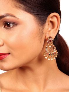 Our latest Anvi Chaandbali earring is a testament to intricate design and meticulous craftsmanship. It features a distinctive tilak stud, with a small pearl and ball drop delicately positioned at the center of the Chandbali, drawing attention to its unique charm. Adorned with Navarathna gemstones (Ruby, pearl, green emerald, red coral, blue sapphire, yellow sapphire, white zircon, moonstone & Hessonite) to this earring radiates elegance. The addition of graceful ball dangles and pearls adds the Pearl Drop Temple Jewelry Danglers For Reception, Temple Jewelry Pearl Drop Danglers For Reception, Pearl Drop Earrings For Reception, Festive Fusion Pearl Earrings With Latkans, Traditional Drop Pearl Earrings For Receptions, Formal Temple Jewelry Pearl Drop Earrings, Reception Chandbalis With Tilla Detail, Temple Jewelry Chandbali Pearl Earrings With Intricate Design, Fusion Pearl Drop Jhumkas For Diwali