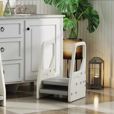 two white step stools in front of a bathroom sink with a potted plant next to it