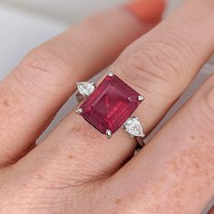 This statement ring features a stunning 5.93 carat red ruby gemstone with two natural earth mined diamonds set in solid 14K gold. This ring makes a lovely July birthstone gift for your loved ones! This ring is made with solid 14K Gold and natural Earth mined SI / G-H diamonds. As listed, this ring is ready to ship. If you're interested in purchasing this setting with a different center stone please message us! Luxury Three Stone Ruby Ring, Formal Red Three Stone Ruby Ring, Formal Red Ruby Ring With Three Stones, Formal Ruby Three Stone Ring, Luxury Red Three Stone Jewelry, Luxury Ruby Three Stone Rings, Luxury Red Three-stone Jewelry, Gia Certified Ruby Ring, Classic Three Stone Ruby Ring