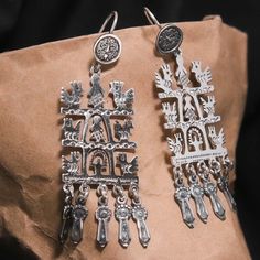 "Sterling Silver .925 Roots and Wings Dangle Drop Earrings Handmade in Taxco, Guerrero These stunning sterling silver Mexican dangle drop earrings are adorned with intricate indigenous motifs of birds and people. Skilled artisans handcrafted them in Taxco, Guerrero, a region of Mexico renowned for its rich history of silver craftsmanship. A beautiful representation of Mexican folk art and a testament to the ancient traditions that continue to thrive in this region. .925 Sterling Silver Made in T Luxury Hand Tooled Silver Jewelry, 925 Sterling Silver Jewelry Mexican, Mexican Silver Jewelry Novica, Roots And Wings, Mexican Folk Art, Linen Shop, San Antonio Tx, Lovely Jewellery, Dream Jewelry