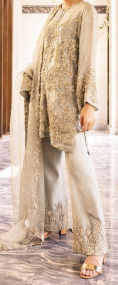 This enchanting and charming outfit is lavishly hand embellished in mason green organza, with beautiful intricate motifs that makes it an ideal outfit for any event. Paired with an elegant raw silk bell-bottom and embellished dupatta scalloped from all four sides. Color: Gray Includes: Shirt Bottom Duppata Festive Hand Embellished Organza Salwar Kameez, Hand Embellished Organza Salwar Kameez With Traditional Drape, Hand Embellished Organza Salwar Kameez, Elegant Hand Embellished Salwar Kameez For Reception, Hand Embellished Sharara For Formal Parties, Elegant Hand-embellished Salwar Kameez For Reception, Hand Embellished Sharara For Party Wear, Glamorous Organza Sets With Resham Embroidery, Hand Embellished Georgette Salwar Kameez For Party