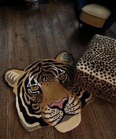 a tiger rug on the floor next to a chair