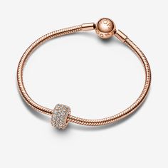 Shine bright from all angles with the Sparkling Pavé Triple-row Charm from the Pandora Moments collection. This cubic zirconia charm is made from a 14k rose gold-plated metal and is designed to shine on its own, or next to one of your existing 14k rose gold-plated charms. Crafted from exactly 85 pavé-set round brilliant-cut clear cubic zirconia, this sparkling pavé charm lends an elevated sparkle to the everyday. - Pandora Sparkling Pavé Triple-row Charm - 14k Rose gold-plated unique metal blend / Cubic Zirconia / Clear Rose Gold Cubic Zirconia Jewelry With Pave Setting, Rose Gold Jewelry With Pave Setting In Cubic Zirconia, Rose Gold Diamond Charm Jewelry, Dazzling Rose Gold Jewelry With Diamond Accents, Luxury Rose Gold Jewelry With Sparkling Stones, Rose Gold Bling Jewelry For Anniversary, Sparkling Rose Gold Diamond Jewelry, Dazzling Rose Gold Bling Jewelry, Elegant Charms Jewelry With Cubic Zirconia