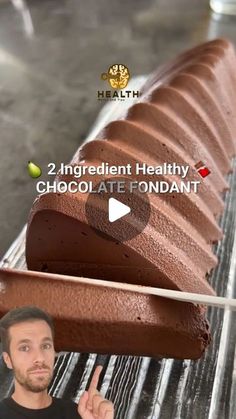 a man points to a chocolate fondant on a conveyor belt with the words, 2 ingredient healthy chocolate fondant