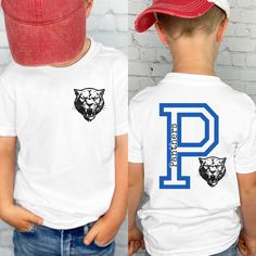 If you're looking for the perfect custom boys school spirit t-shirt, school shirt, mascot shirt, boys pink out shirt, school colors shirt, or personalized boys gift for school then look no further!  PRODUCT DETAILS For printing, we use Bella Canvas, Gildan SoftStyle, and Comfort Colors brand shirts, which are the best in the industry. Brand of shirt will be noted in the description. If you would prefer a different brand then the one being used, please message us and we'll be happy to accommodate Customizable Crew Neck School T-shirt, Varsity Cotton T-shirt With Custom Print, Pre-shrunk T-shirt For School Team Spirit, Sporty School T-shirt With Name Print, Casual T-shirt With Name Print For School Events, School Spirit Tops With Name Print For School Events, Collegiate T-shirt With Team Name For School, Varsity Style Customizable T-shirt For College, Customizable Cotton T-shirt For School Spirit