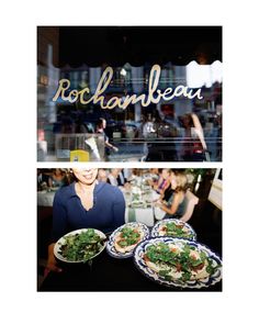 a woman is holding two plates of food in front of a restaurant sign that says rochanbeau