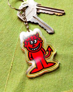 a key chain with an image of a cartoon character on it and two keys attached to it