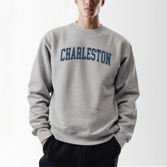 Explore the timeless charm of Charleston in our Charleston, SC, Collegiate Crewneck Sweatshirt. This classic sweatshirt, crafted from a durable polyester and cotton blend, offers comfort and style for strolling down cobblestone streets or exploring historic homes. The fabric ensures you stay warm on chilly evenings by the harbor or cool mornings at the farmers' market. With a ribbed knit collar that retains its shape and elasticity, this sweatshirt is designed to last. The seamless, tubular knit Sophisticated Lifestyle, Comfort Show, Southern Elegance, Seamless Knitting, Hometown Pride, Casual Night Out, Cozy Fits, Charleston Sc, Historic Homes